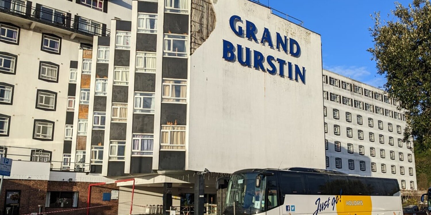 Two people injured after exterior of Britannia hotel falls on coach