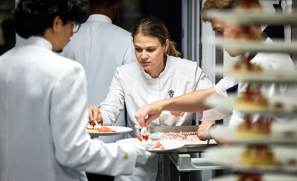 Sarah Frankland, executive chef at Pennyhill Park, adds the finishing touch to a dessert of Eton mess with Pennyhill Park honey, New Forest strawberries and an English apple cider balsamic sorbet